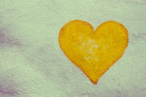 grunge painting heart on the painted concrete wall