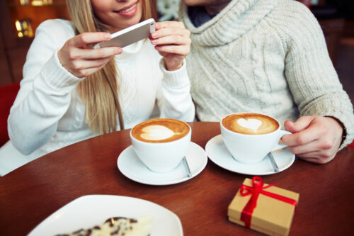 graphicstock young dates in sweaters photographing cappuccino while sitting in cafe S7GRQv8z4Z